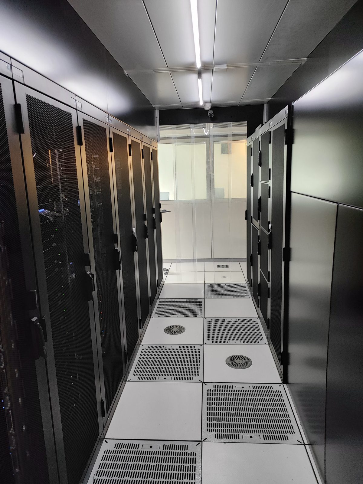 Cold corridor of the AlpineDC datacenter in Lausanne with rows of server racks