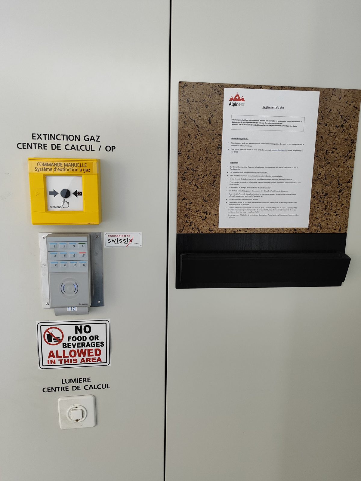Interior entrance wall of the AlpineDC datacenter in Lausanne with safety signage